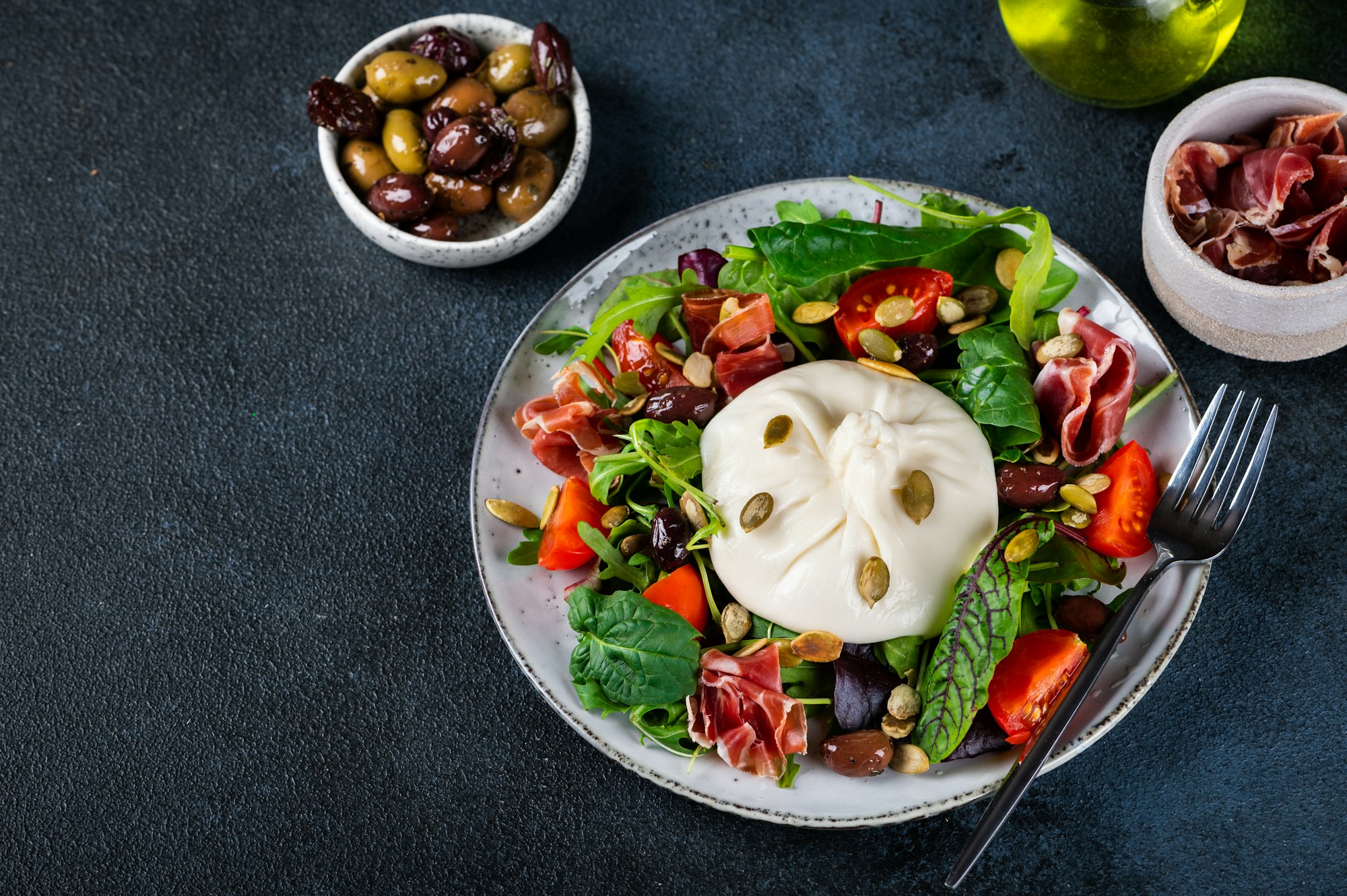 Burrata salad with tomatoes and salad mix. Healthy eating concept. Keto diet salad